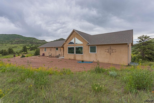 rear view of house with a mountain view