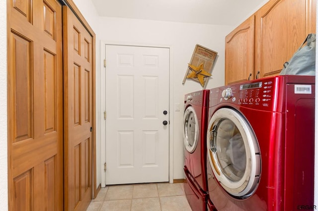 laundry area with cabinets, light tile patterned floors, and independent washer and dryer