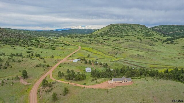 birds eye view of property featuring a mountain view and a rural view