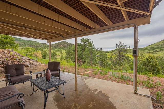 view of patio / terrace featuring a mountain view