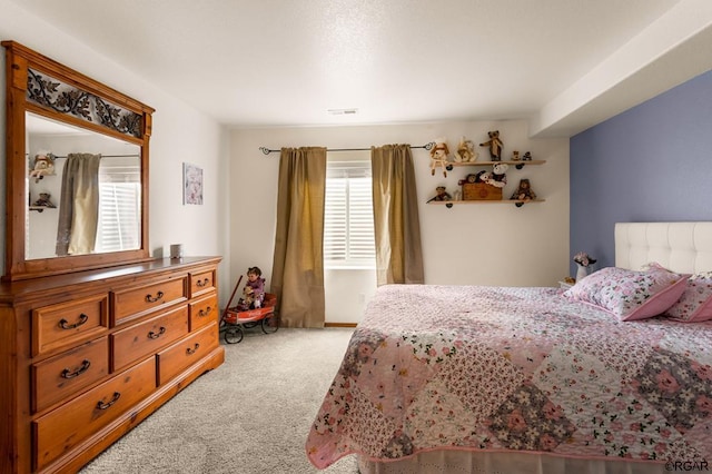 carpeted bedroom with multiple windows