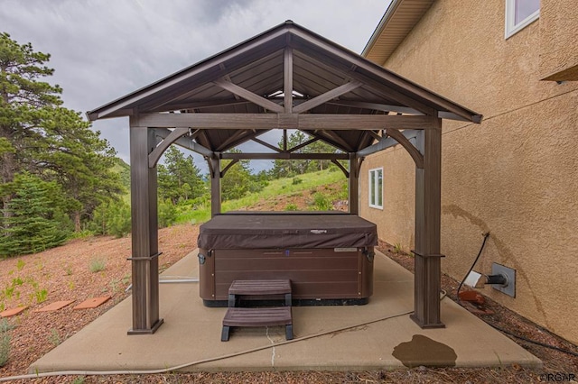 view of patio / terrace featuring a gazebo and a hot tub