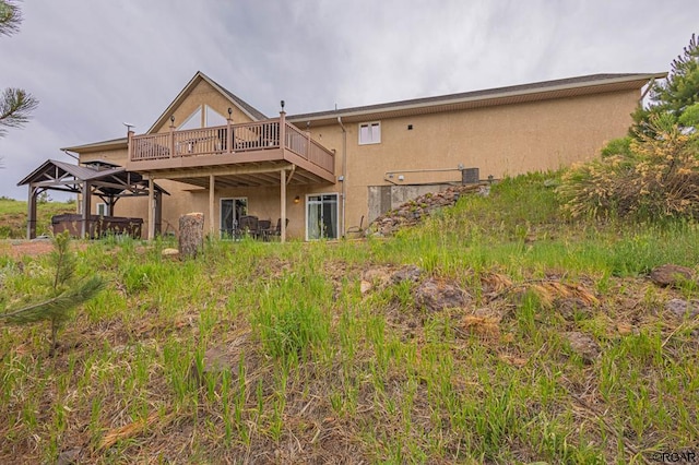 back of property featuring a deck