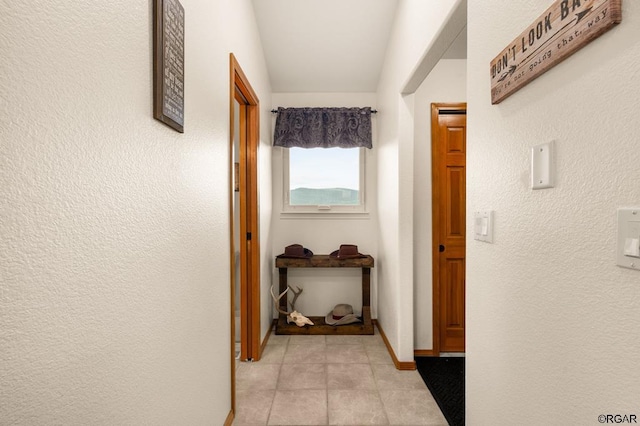 hall featuring light tile patterned flooring