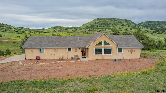 back of property featuring a mountain view