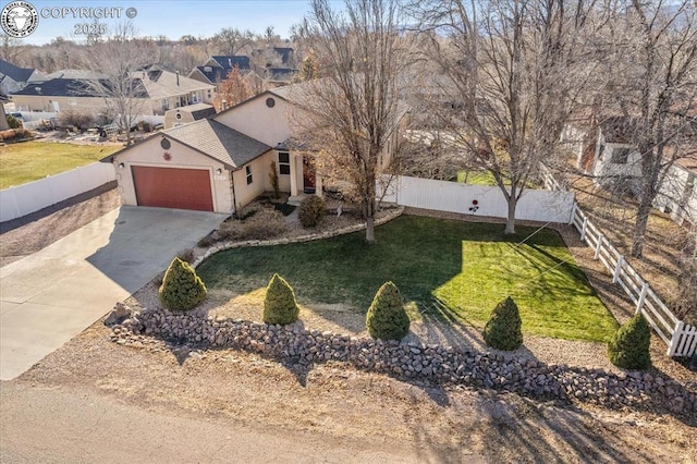 view of front of property featuring a garage and a front yard