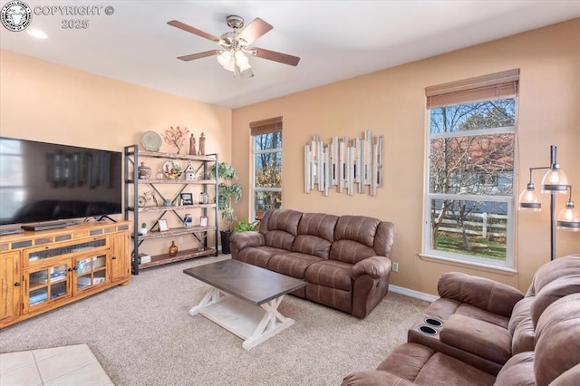 carpeted living room featuring plenty of natural light and ceiling fan