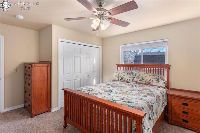 carpeted bedroom featuring ceiling fan and a closet