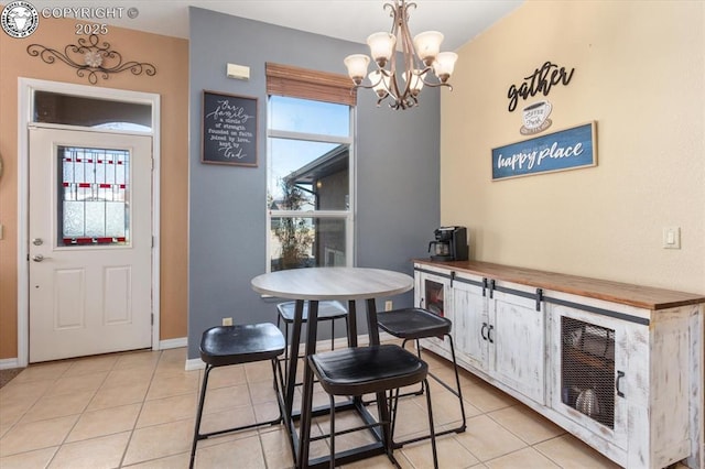 dining space featuring a notable chandelier and light tile patterned flooring