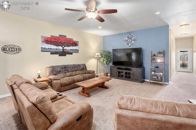 living room featuring ceiling fan and carpet floors