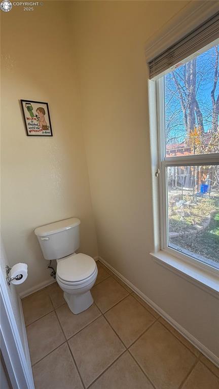 bathroom with tile patterned floors and toilet