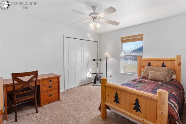 bedroom with ceiling fan, light carpet, and a closet