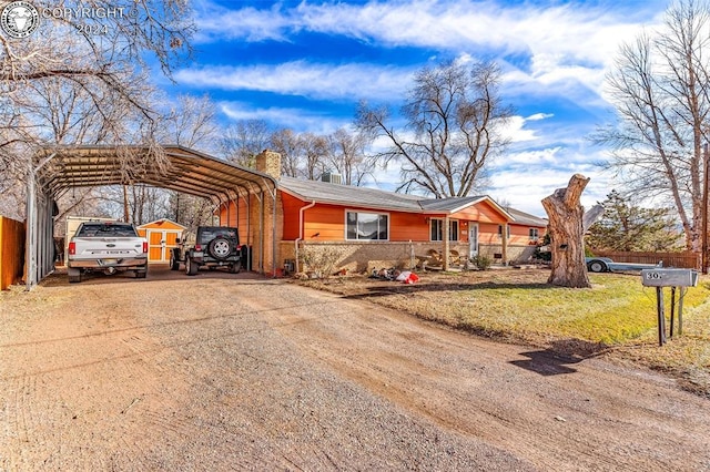 ranch-style home featuring a carport