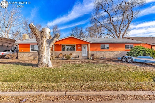 single story home with a carport and a front lawn