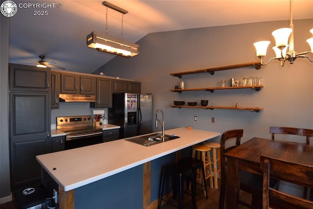 kitchen featuring lofted ceiling, a breakfast bar, sink, appliances with stainless steel finishes, and pendant lighting