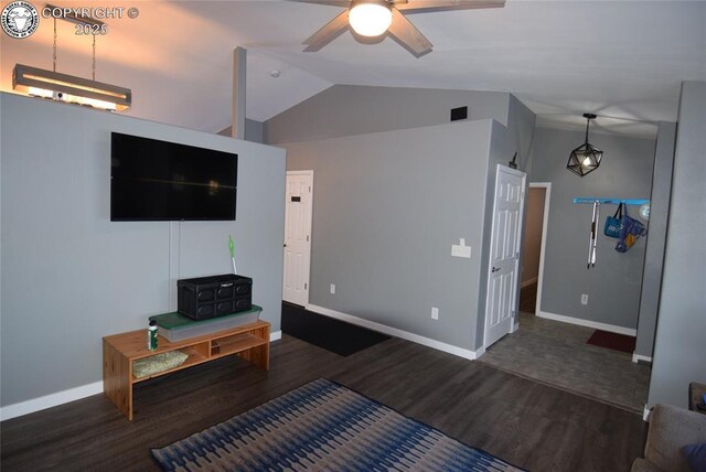 living room featuring lofted ceiling, dark wood-type flooring, and ceiling fan