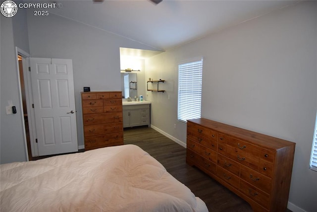 bedroom featuring ensuite bathroom, vaulted ceiling, and dark hardwood / wood-style floors