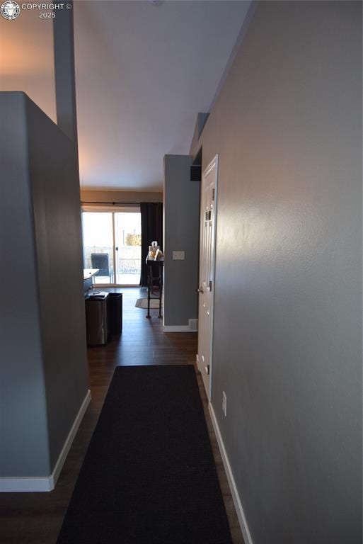 hallway with dark hardwood / wood-style flooring