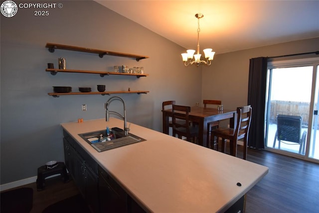 kitchen with lofted ceiling, sink, a chandelier, hanging light fixtures, and dark hardwood / wood-style floors