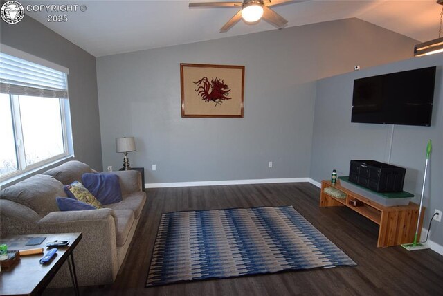 living room featuring dark wood-type flooring, ceiling fan, and vaulted ceiling