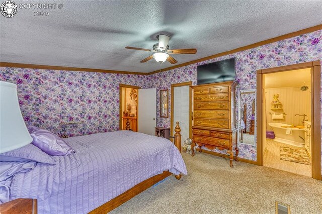 575 Wykagyl Rd, Westcliffe, CO 81252 - carpeted bedroom featuring wallpapered walls, ornamental molding, ensuite bath, a textured ceiling, and visible vents