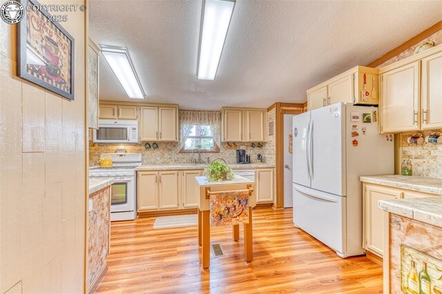575 Wykagyl Rd, Westcliffe, CO 81252 - kitchen featuring light wood finished floors, decorative backsplash, light countertops, and white appliances