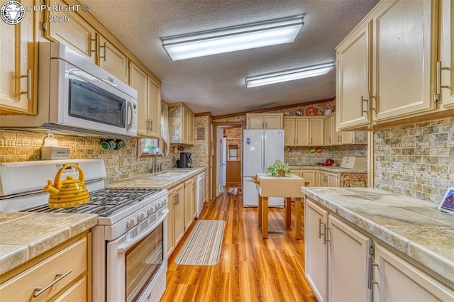 575 Wykagyl Rd, Westcliffe, CO 81252 - kitchen with white appliances, light wood-type flooring, a textured ceiling, a sink, and lofted ceiling