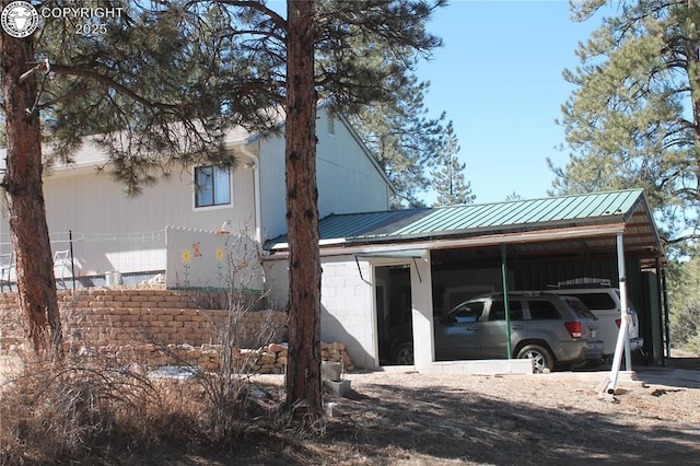 view of front of property featuring metal roof and an attached carport