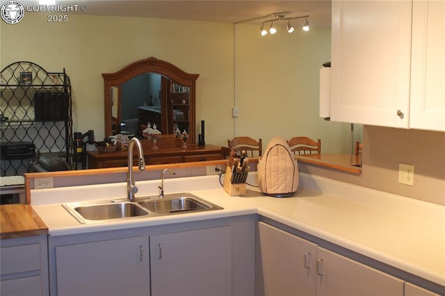 kitchen featuring a sink and white cabinets