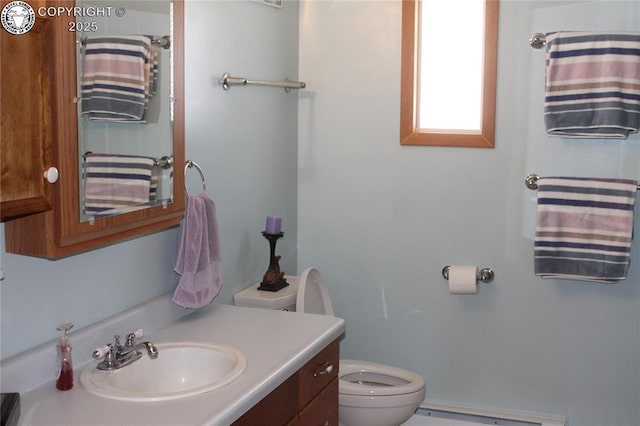 bathroom with a baseboard radiator, a shower with curtain, vanity, and toilet