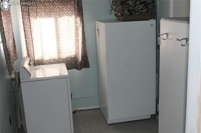 laundry room featuring washer / dryer and tile patterned flooring