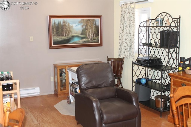 sitting room featuring baseboards, baseboard heating, and wood finished floors