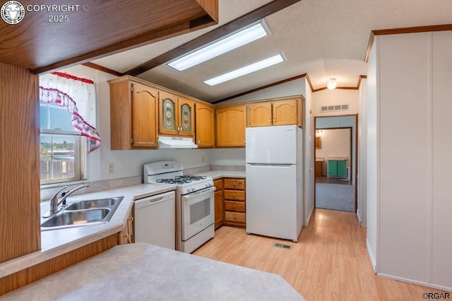 kitchen with white appliances, lofted ceiling, light hardwood / wood-style floors, and sink