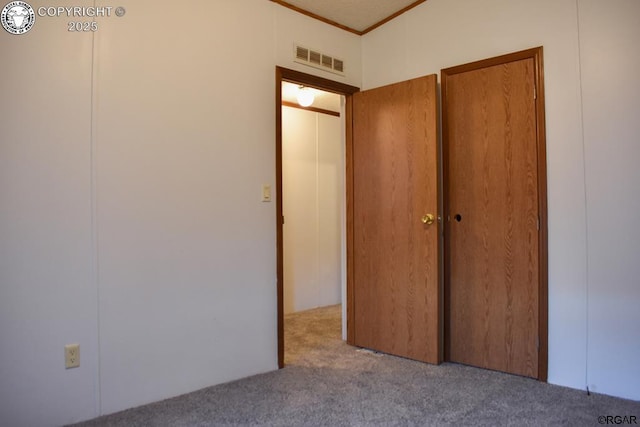 unfurnished bedroom featuring light carpet