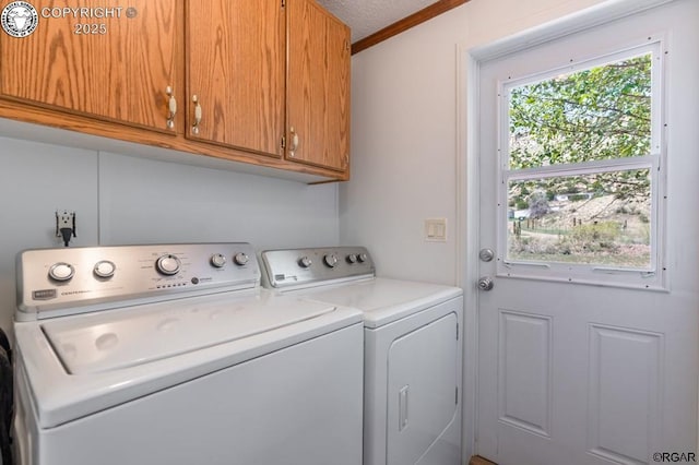 washroom with separate washer and dryer, ornamental molding, cabinets, and a textured ceiling