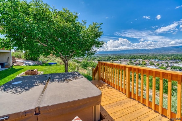 deck featuring a mountain view and a hot tub