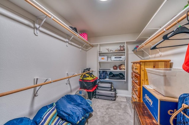 walk in closet featuring dark carpet