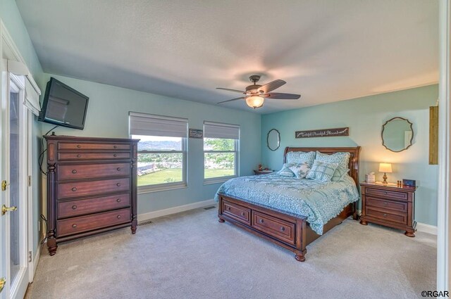 bedroom with light carpet and ceiling fan