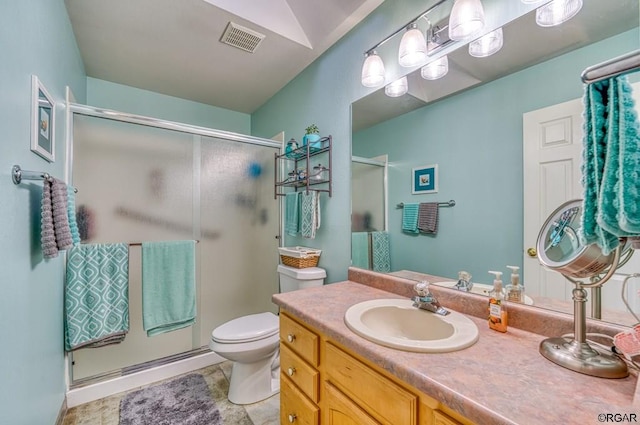 bathroom with vanity, toilet, and an enclosed shower