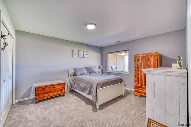 carpeted bedroom with a closet