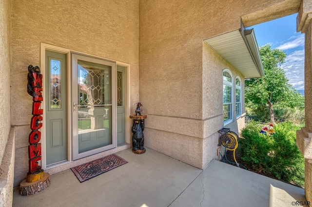 entrance to property featuring a patio area