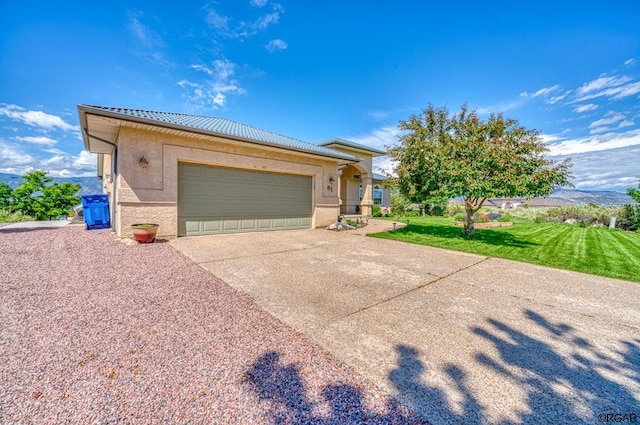 view of front of property featuring a garage and a front lawn