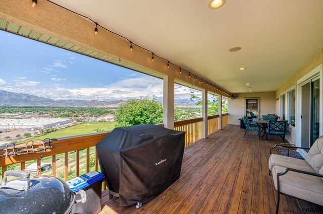 deck with a mountain view and grilling area