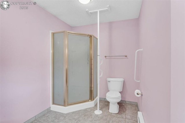 bathroom featuring toilet, a shower with shower door, and a textured ceiling