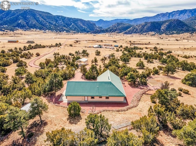 drone / aerial view with a mountain view and a rural view