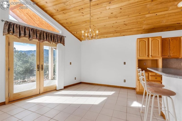 unfurnished dining area with french doors, wood ceiling, a chandelier, vaulted ceiling, and light tile patterned floors