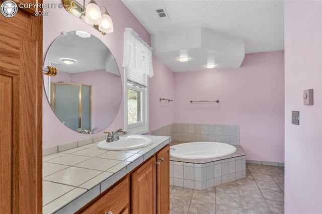 bathroom featuring tile patterned floors, separate shower and tub, and vanity