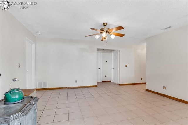 tiled spare room featuring ceiling fan and a textured ceiling