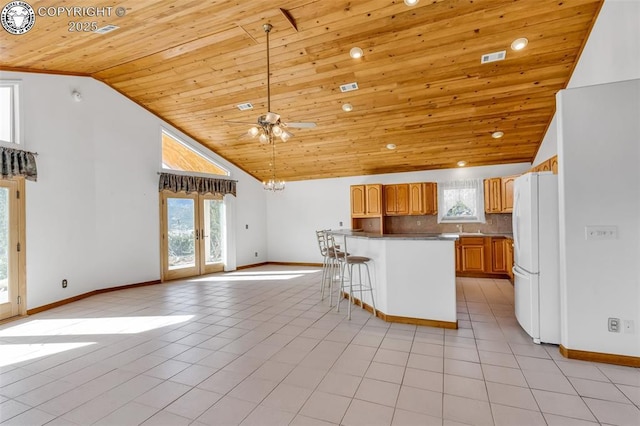 kitchen featuring light tile patterned flooring, french doors, wood ceiling, high vaulted ceiling, and white refrigerator