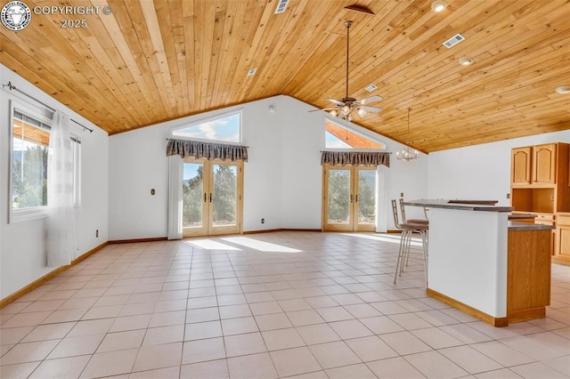 interior space featuring light tile patterned flooring, vaulted ceiling, ceiling fan, wood ceiling, and french doors